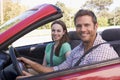 Couple in convertible car smiling Royalty Free Stock Photo