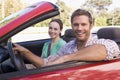 Couple in convertible car smiling Royalty Free Stock Photo