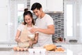 Couple cooking bakery in kitchen room, Young asian man and woman together Royalty Free Stock Photo