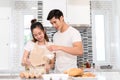 Couple cooking bakery in kitchen room, Young asian man and woman together Royalty Free Stock Photo