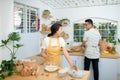 Couple cooking bakery in kitchen room, Young asian man and woman together making cake and bread with egg Royalty Free Stock Photo