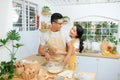 Couple cooking bakery in kitchen room, Young asian man and woman together making cake and bread with egg Royalty Free Stock Photo