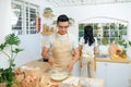 Couple cooking bakery in kitchen room, Young asian man and woman together making cake and bread with egg Royalty Free Stock Photo