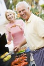 Couple Cooking On A Barbeque Royalty Free Stock Photo