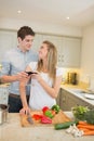 Couple cooking and clinking wine glasses Royalty Free Stock Photo