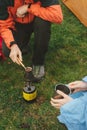 Couple cooking coffee on primus outdoors