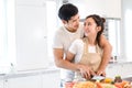 Couple cooking food in kitchen room, Young Asian man and woman together Royalty Free Stock Photo