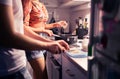 Couple cooking in home kitchen. Two people preparing a meal and dinner together. Husband and wife romantic date night. Royalty Free Stock Photo