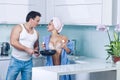 Couple cooking in kitchen. Sexy young family or lovers in kitchen cooking breakfast.