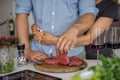 Couple Cooking meat together. Hobby Lifestyle Concept. Royalty Free Stock Photo