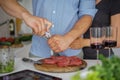 Couple Cooking meat together. Hobby Lifestyle Concept. Royalty Free Stock Photo