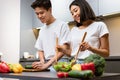 Couple Cooking Salad In Kitchen, Husband Helping Wife Prepare Dinner Royalty Free Stock Photo