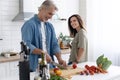 Couple cooking together in their kitchen at home. Royalty Free Stock Photo