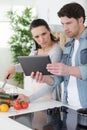 couple cooking togheter with digital tablet Royalty Free Stock Photo