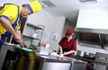 Couple of cooks in a restaurant kitchen Royalty Free Stock Photo