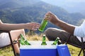 Couple and cool box with bottles of beer in nature, closeup Royalty Free Stock Photo