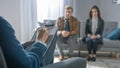 Couple on a Counseling Session with Psychotherapist. Foreground Focus on Back of the Therapist Royalty Free Stock Photo