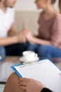 Couple counselling. Female psychotherapist with clipboard and ha Royalty Free Stock Photo