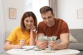 Couple counting money at table