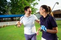 Couple at the course playing golf and looking happy - Image Royalty Free Stock Photo