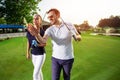 Couple at the course playing golf and looking happy - Image Royalty Free Stock Photo