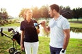 Couple at the course playing golf and looking happy - Image Royalty Free Stock Photo