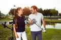 Couple at the course playing golf and looking happy - Image Royalty Free Stock Photo