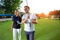 Couple at the course playing golf and looking happy Royalty Free Stock Photo