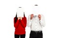 Couple covering their faces with documents