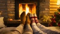 Couple put feet up next to a cozy warm open fire