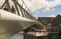 A couple crossing the new footbridge across the new flood barrier on the River Lagan at the Donegall Quay in Belfast