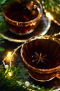 Couple cups of hot spicy tea with anise and cinnamon, selective focus