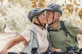 Couple of cute and sweet seniors in love enjoying together nature outdoors having fun with bikes. Old man kissing his wife smiling Royalty Free Stock Photo