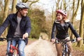 Couple On Cycle Ride In Winter Countryside