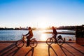 Couple Cycling against sunset view at La Marina de Valencia near Playa de las Arena in Valencia