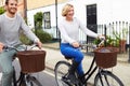 Couple Cycling Along Urban Street Together