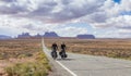 A couple cycling through Monument Valley