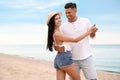 Lovely couple dancing on beach near sea Royalty Free Stock Photo