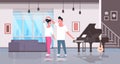 Couple dancing man woman happy lovers home hall musical instruments piano guitar modern apartment interior male female