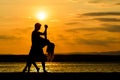 A couple dancing by the sea at sunset Royalty Free Stock Photo