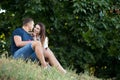 Couple on a date resting under the trees Royalty Free Stock Photo