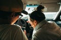 The couple decides where to go. They look at the phone. Navigation. In the car