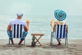 Couple on a deck chair relaxing on the beach. Royalty Free Stock Photo