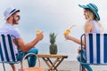 Couple on a deck chair relaxing on the beach. Royalty Free Stock Photo