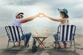 Couple on a deck chair relaxing on the beach. Royalty Free Stock Photo