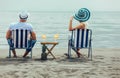 Couple on a deck chair relaxing on the beach. Royalty Free Stock Photo