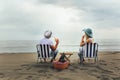 Couple on a deck chair relaxing on the beach. Royalty Free Stock Photo