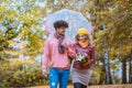 Couple with different ethnicities having a autumn walk in the park Royalty Free Stock Photo