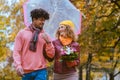 Couple with different ethnicities having a autumn walk in the park Royalty Free Stock Photo