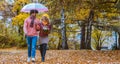 Couple with different ethnicities having a autumn walk in the park Royalty Free Stock Photo